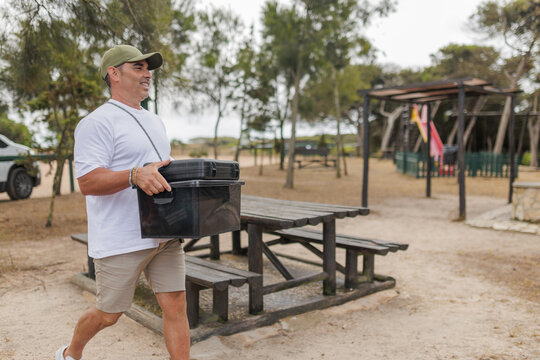 Man preparing picnic table for outdoor meal