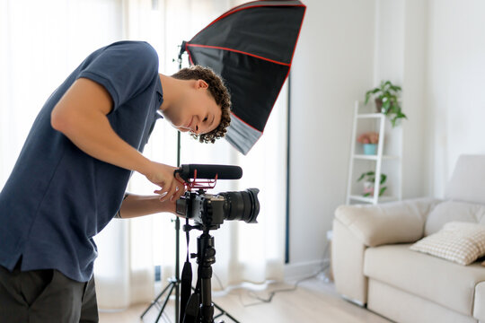 Content creator adjust camera in home video studio