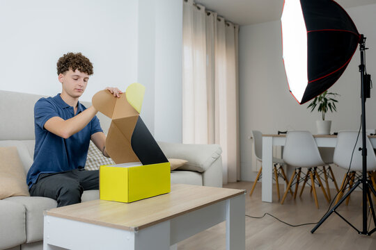 Content creator unbox product with studio lighting at home