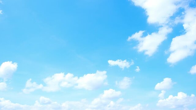 Bright white cumulus clouds evolve above a brilliant azure sky in this blue sky cloud timelapse video, revealing shifting formations, gentle airflow, warm sunlight, and pleasant daytime weather. 4k.
