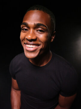 Young Black man smiling broadly looking at camera