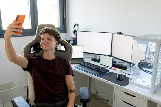 Young man takes selfie at gaming computer setup