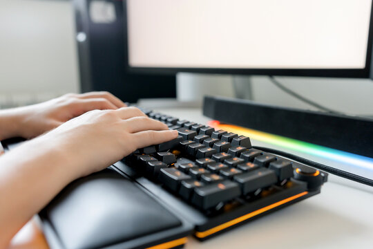 Young man use gaming computer with AI tools at desk