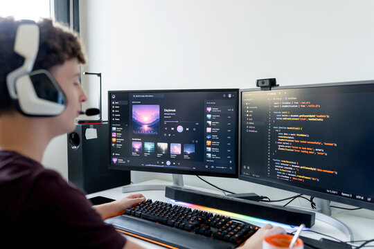 Young man use gaming computer with code and music
