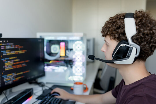 Young man use AI tools on gaming computer with headset