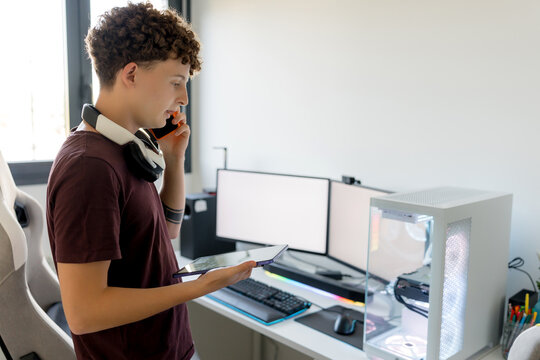Young man with headset at gaming computer workstation