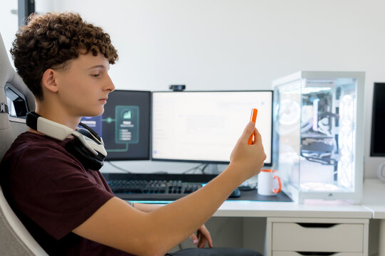 Young man using AI tools at gaming computer desk