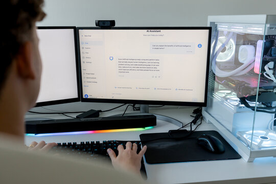 Young man using AI assistant on gaming computer