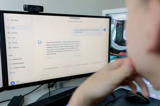 Young man using AI assistant on gaming computer