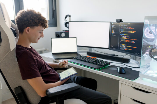 Young man use AI tool at gaming computer desk