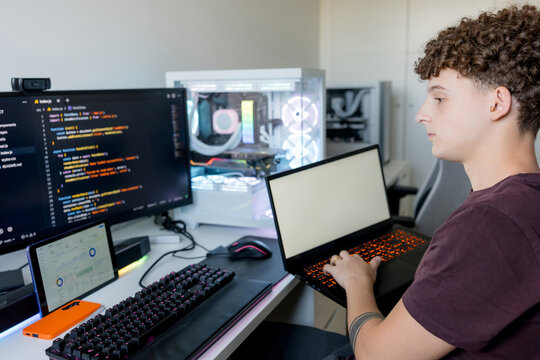 Young man using AI tools on gaming computer at home