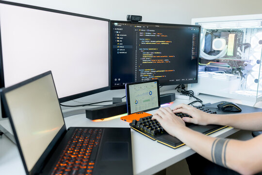 Young man code on gaming computer with AI tools