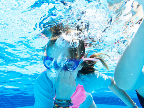 Young girl swimming underwater