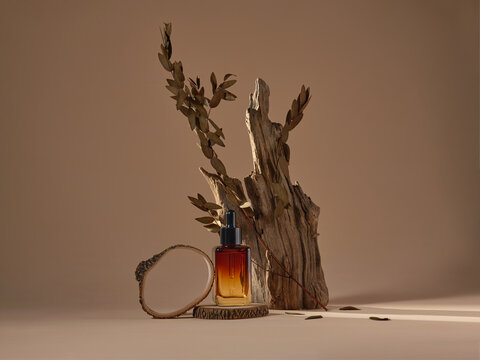 An amber serum bottle is showcased on a wooden platform