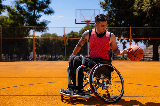 Wheelchair Basketball Athlete Dribbling on Outdoor Court