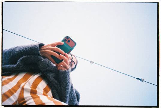 Person Using Smartphone While Looking up in the Sky