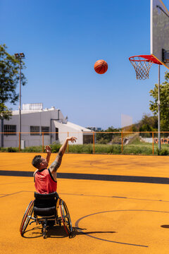 Wheelchair Basketball Player Shooting at Outdoor Hoop