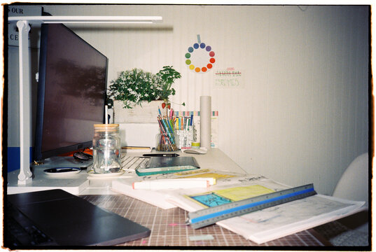 Workspace With Tools and Plants Near Computer
