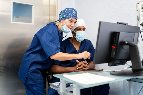 Medical team collaborating and reviewing data on monitor