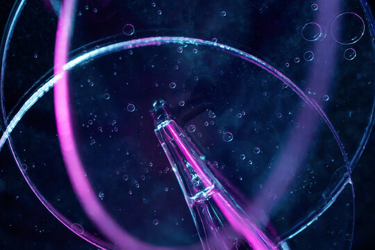Neon laboratory glassware with bubbles and abstract science