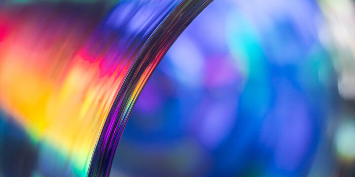 Abstract rainbow light spectrum through curved glass lens