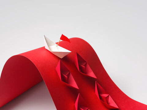 White paper boat with red flag leads other red boats