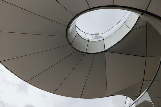 Modern Spiral Staircase in an Urban Setting With a Cloudy Sky