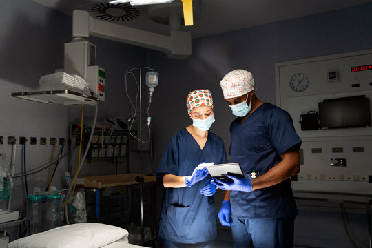 Surgery team reviewing patient data on tablet