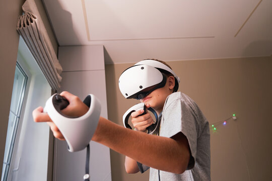 Teen boy immersive virtual reality gaming experience with VR headset