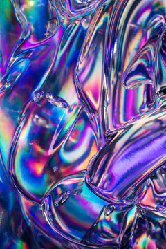 Iridescent holographic glass texture with vibrant rainbow reflection