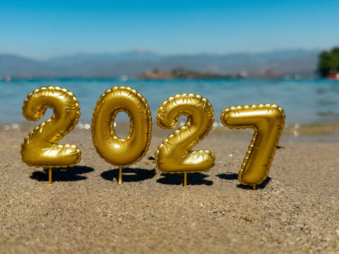 Golden 2027 number decoration on a sandy beach