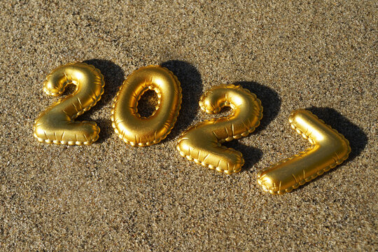 Golden 2027 number over the beach sand