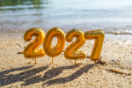 Golden 2027 New Year number on sunny beach sand
