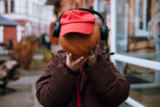 Teenager girl hold pumpkin at autumn market stall