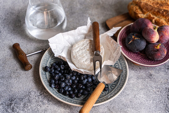 Rustic cheese board with blueberry, fig and sourdough bread