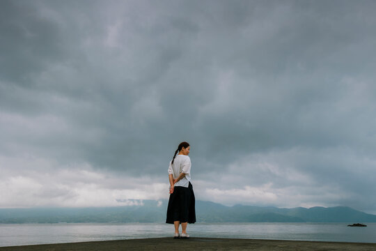 A Woman Contemplating by the Sea Before a Storm