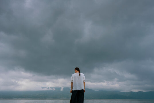 A Woman Contemplating by the Sea Before a Storm
