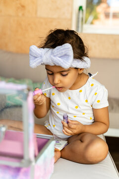 Girl Applying Lip Gloss At Home