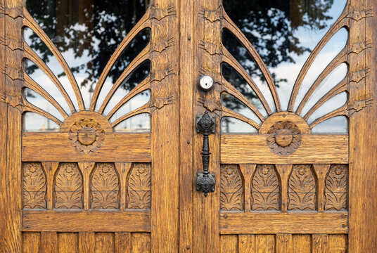 Ornate art nouveau wooden door with floral carvings