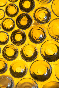 Macro view of handmade yellow glass plate with circular bumps