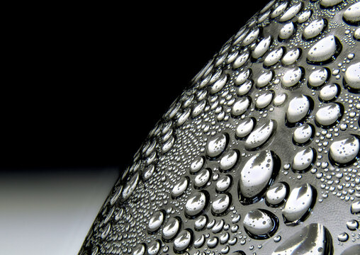 Water droplets on curved plastic surface in macro closeup