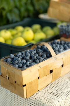 Fresh blueberry harvest in wooden baskets at a market