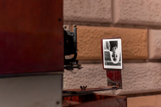 Vintage analog camera with instant film on urban street