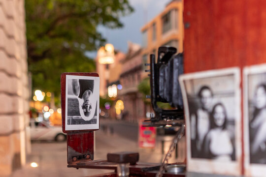 Vintage camera display with instant photo on urban street
