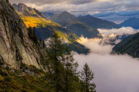 Dramatic cloud-filled valley in the French Alps at sunrise