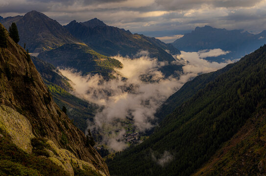 Misty valley beneath Aiguilles Rouges in the French Alps