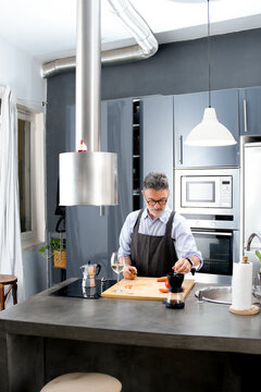 Mature man prepare food in modern home kitchen