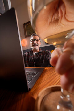 Mature man on video call from home office
