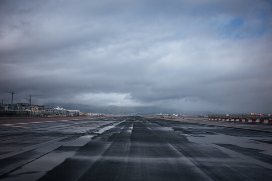 Wet runway under storm clouds at Gibraltar Airport