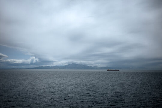 Gibraltar coastline beneath dramatic cloudy sky and sea